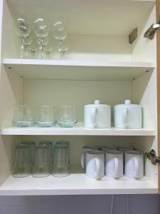 a shelf filled with glasses and mugs and jars at 4 BRH for Large Group Birmingham in Birmingham