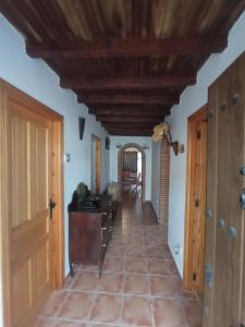 a hallway leading to the living room and dining room at Casa rural Labrador a 9k de Monfragüe in Torrejón el Rubio
