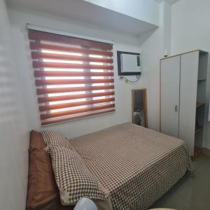 Postel nebo postele na pokoji v ubytování HOMELY @ Green 2 Residences SMDC DLSUMC