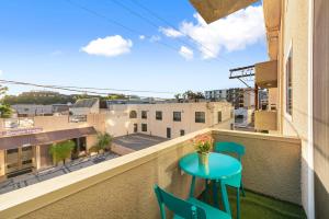 a small table on a balcony with a view of a city at Beverly Hills Chic 2 bed 2bath with Patio and Parking 309 in Los Angeles