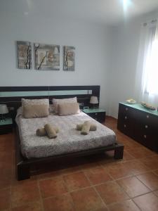 a bedroom with a bed with two pillows on it at Las Vistas in Arcos de la Frontera