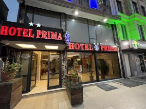 a hotel pharmacy with neon signs on a building at Hotel Prima in Istanbul