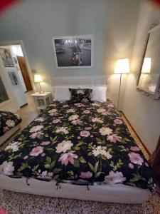 a bedroom with a bed with a floral bedspread at Italian Vintage House in Como