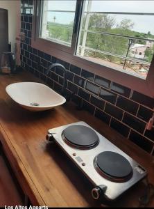 a bathroom with a white sink and a counter with a sink at Altos apparts in Estancia Vieja