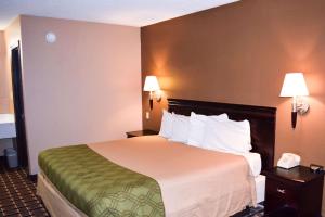 a hotel room with a large bed and two lamps at Richburg Inn in Richburg