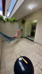 a room with a hammock on the floor of a building at Área vip maranduba in Ubatuba