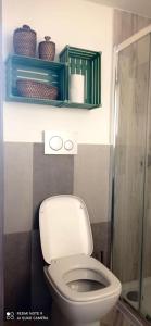 a bathroom with a toilet and a glass shower at La casita in Civitavecchia