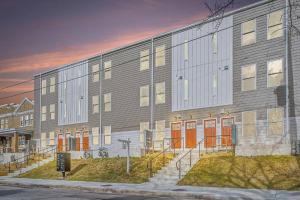 a large building with orange doors on a street at Spacious 3Bedroom Duplex with Rooftop Deck! in Washington, D.C.