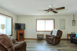 a living room with two chairs and a flat screen tv at 531 Dolliver in Pismo Beach