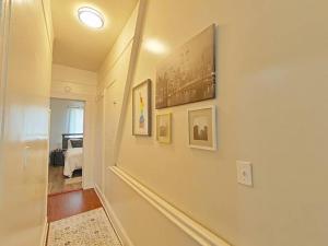 a hallway with pictures on the walls of a home at Elegant 3Br Apt Yankee stadium in Melrose