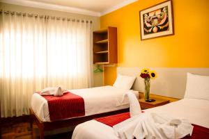 Postel nebo postele na pokoji v ubytování HOSTAL CASA INKAS