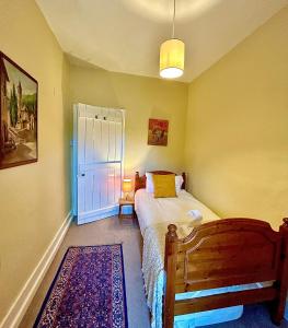 a small bedroom with a bed and a window at Springbank Cottage in Stroud