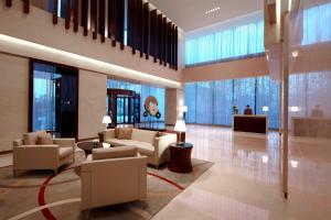 a lobby with couches and chairs in a building at Courtyard by Marriott Shanghai Jiading in Jiading