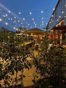a building with lights and plants in front of it at Sweet Home in Milano smart district in Milan