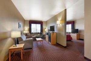 a hotel room with a couch and a living room at Best Western Golden Prairie Inn and Suites in Sidney