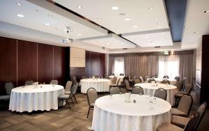 a conference room with tables and chairs and tablesktop at DoubleTree by Hilton Cape Town Upper Eastside in Cape Town