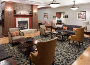 a living room with furniture and a fireplace at Homewood Suites by Hilton Irving-DFW Airport in Irving