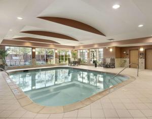 a large swimming pool in a hotel lobby at Homewood Suites by Hilton Irving-DFW Airport in Irving