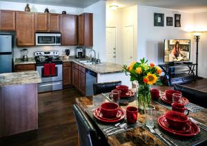 a kitchen with a table with red dishes on it at Luxury Vacation Rentals by Meridian CondoResorts in Scottsdale