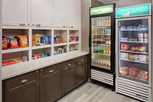 a kitchen with a refrigerator with food in it at Homewood Suites by Hilton Dallas Market Center in Dallas