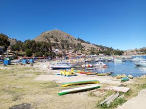 a group of boats on the shore of a harbor at Hostal Puerto Alegre in Copacabana