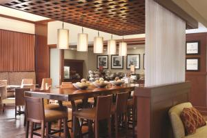 a dining room with a large table and chairs at Hampton Inn & Suites Mystic in Mystic