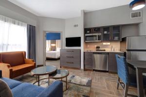 a living room with a couch and a table in a room at Homewood Suites by Hilton Jackson-Ridgeland in Ridgeland