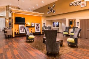 uma sala de espera com cadeiras e uma televisão de ecrã plano em Hampton Inn & Suites Orlando-East UCF em Orlando
