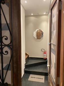 a hallway with a stairway leading to a room at Hostel 364 Santos Dorm Privativo 2 com Alexa in Santos