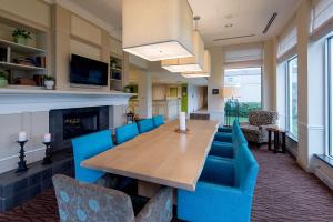 a dining room with a table and blue chairs at Hilton Garden Inn Owings Mills in Owings Mills