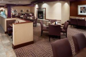 a restaurant with chairs and tables and a bar at DoubleTree Suites by Hilton Hotel Cincinnati - Blue Ash in Sharonville