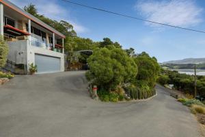 an empty driveway in front of a house at The Bolthole - Charteris Bay Holiday Home in  Lyttelton +18 photos