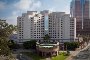 a large white building with a clock on top of it at Hilton Long Beach Hotel in Long Beach