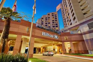 un'auto parcheggiata di fronte a un hotel di Hilton Long Beach Hotel a Long Beach