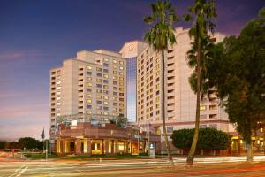 a large hotel building at night with a street at Hilton Long Beach Hotel in Long Beach