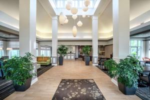 a lobby with potted plants in a building at Hilton Garden Inn Louisville East in Louisville