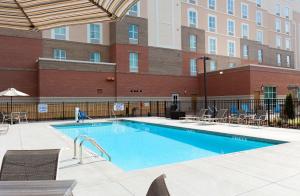 a large swimming pool with chairs and a building at Hampton Inn and Suites Fort Mill, SC in Fort Mill