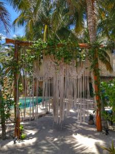 a wedding altar on the beach with a palm tree at Hotel Boutique Can Cocal El Cuyo in El Cuyo