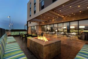 een patio met een vuurplaats en tafels en stoelen bij Home2 Suites By Hilton Richland in Richland