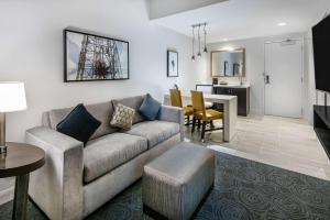 a living room with a couch and a dining room at Embassy Suites by Hilton Houston West - Katy in Houston