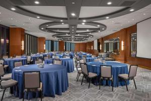 a banquet hall with blue tables and chairs at The Marquette Hotel, Curio Collection by Hilton in Minneapolis