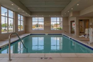 a swimming pool in a hotel room with a large window at Hampton Inn Bourbonnais Kankakee in Bourbonnais