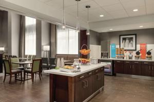 a kitchen and dining room with a table and chairs at Hampton Inn Brooklyn Park in Brooklyn Park