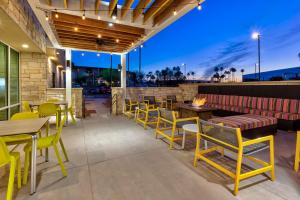 a patio with tables and chairs and a fire pit at Home2 Suites By Hilton Tucson Airport, Az in Tucson