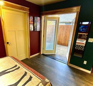 a room with a bedroom with a door and a room with a door at Cedar Mountain -Suite C in Grants Pass