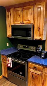 a kitchen with a stove and a microwave at Cedar Mountain -Suite C in Grants Pass