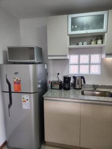 La cuisine est équipée d'un réfrigérateur et d'un four micro-ondes. dans l'établissement Departamento excelente ubicación, à Godoy Cruz
