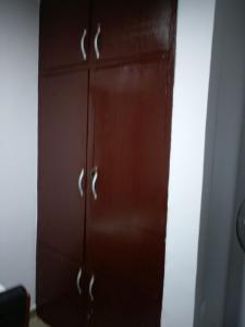 a brown cabinet with silver handles in a room at chinaka guest house 24hr light in Lagos