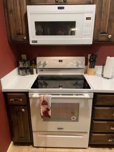 a kitchen with a stove with a microwave above it at Cedar Mountain Suite D in Grants Pass