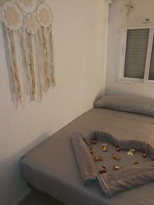 a bed with some figurines on it in a room at Habitacion en Castilleja de la Cuesta in Castilleja de la Cuesta